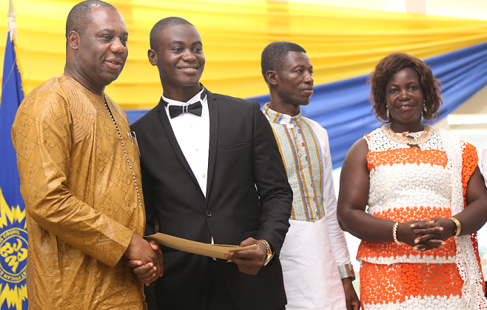   Dr Matthew Opoku Prempeh (left) presenting the overall best award to Master Pius Kyere. Those with him are his parents.  Picture: EMMANUEL ASAMOAH ADDAI